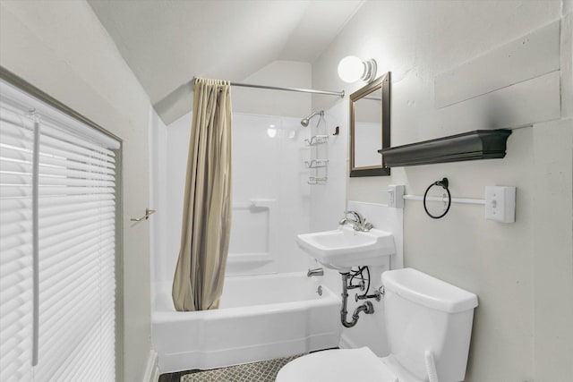 bathroom with lofted ceiling, toilet, and shower / bath combo with shower curtain