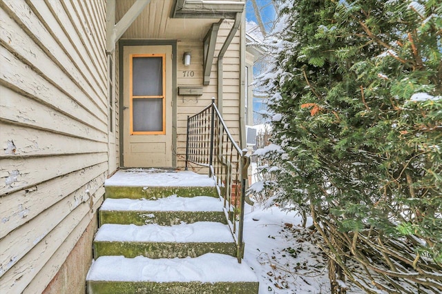 view of snow covered property entrance