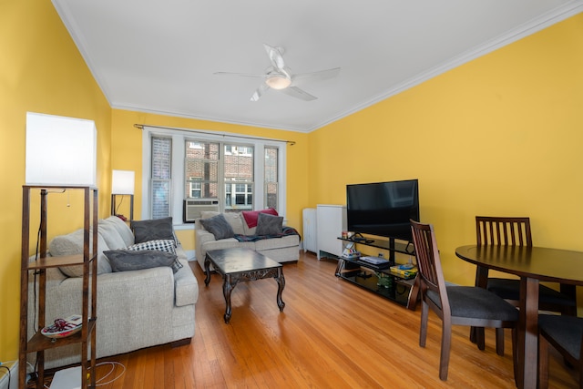 living room featuring ornamental molding, radiator, light wood-type flooring, and ceiling fan