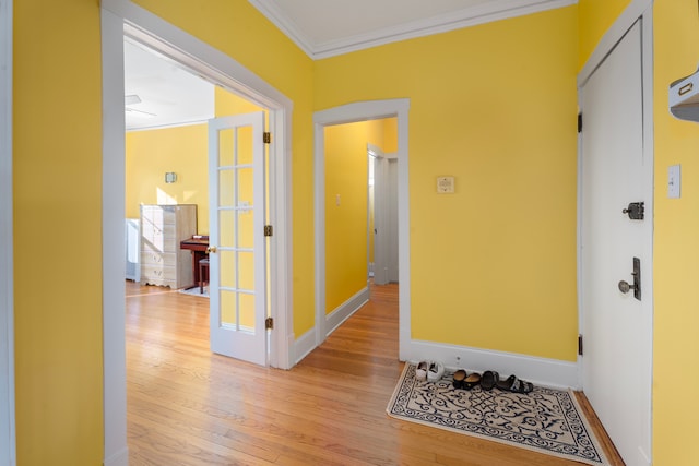 hallway featuring ornamental molding and light wood-type flooring