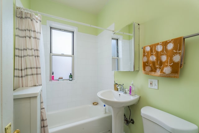 bathroom with toilet and shower / tub combo with curtain