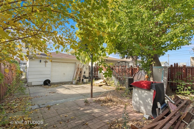 view of patio with an outbuilding and a garage