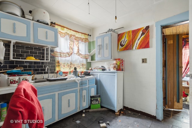 kitchen with blue cabinetry and decorative backsplash