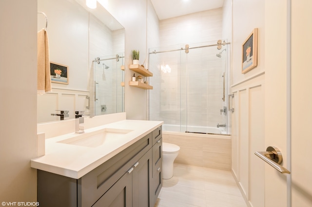 full bathroom featuring toilet, combined bath / shower with glass door, vanity, and tile patterned flooring