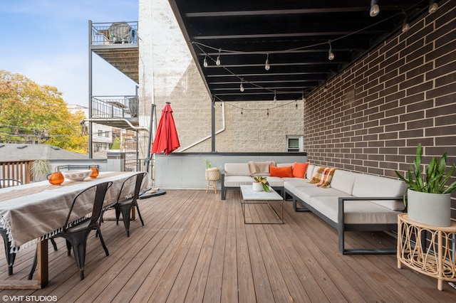 wooden terrace with an outdoor hangout area