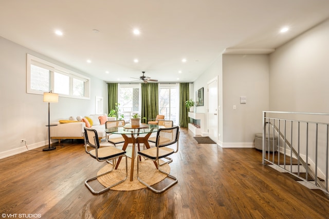 dining room featuring dark wood-type flooring, a wealth of natural light, and ceiling fan