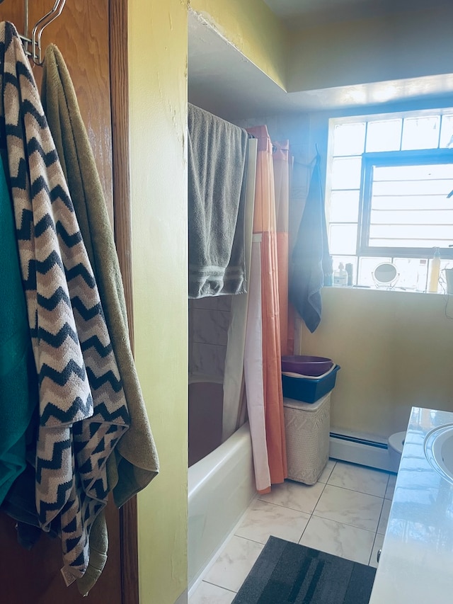 bathroom featuring baseboard heating, vanity, and shower / bath combination with curtain