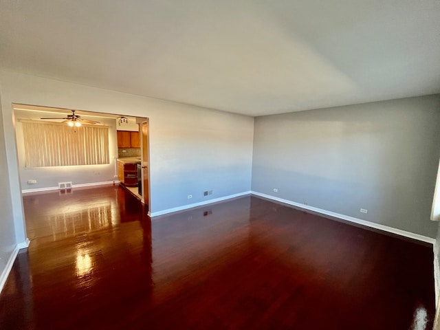 spare room featuring ceiling fan and dark hardwood / wood-style floors