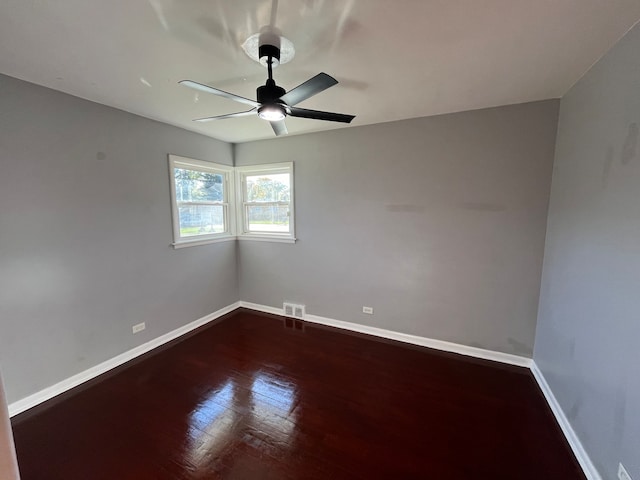 unfurnished room featuring dark hardwood / wood-style floors and ceiling fan