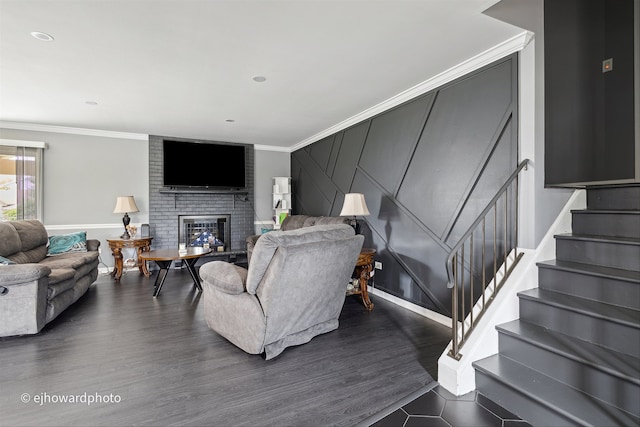 living room with ornamental molding, a fireplace, and dark hardwood / wood-style flooring