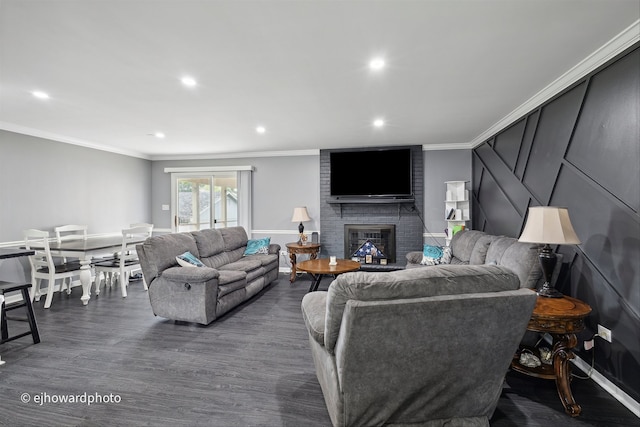 living room with crown molding, a brick fireplace, and dark hardwood / wood-style floors