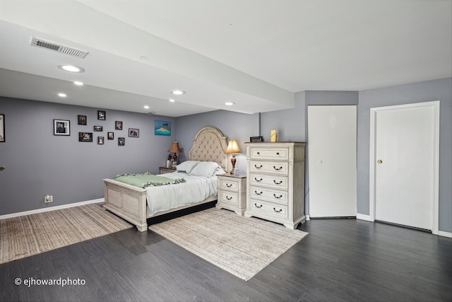 bedroom with dark wood-type flooring