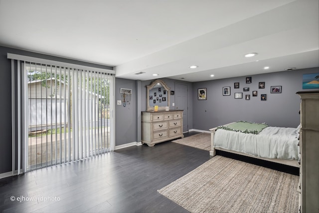 bedroom featuring access to exterior and dark hardwood / wood-style flooring