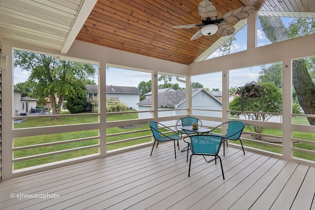 sunroom featuring ceiling fan, wooden ceiling, and lofted ceiling