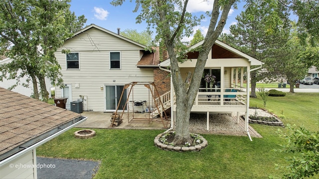 back of house with a patio, an outdoor fire pit, a lawn, and cooling unit