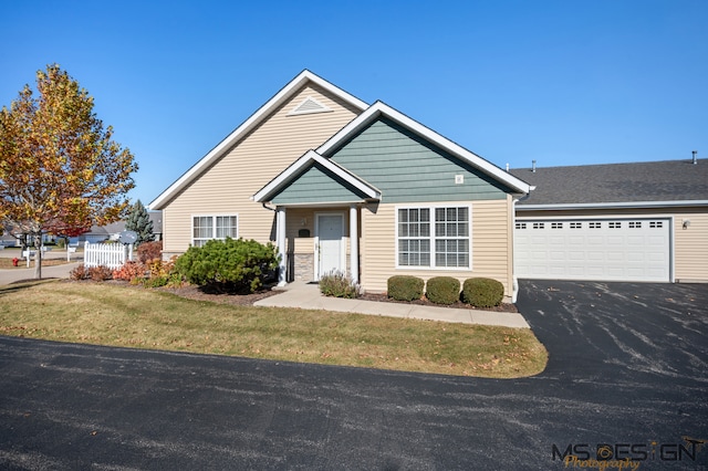 view of front of home with a front lawn and a garage