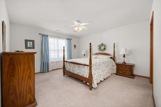 bedroom with ceiling fan and light colored carpet