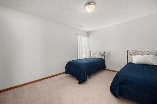 carpeted bedroom with a textured ceiling