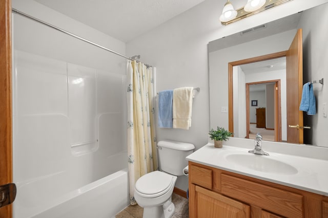 full bathroom with toilet, tile patterned flooring, shower / tub combo with curtain, vanity, and a textured ceiling