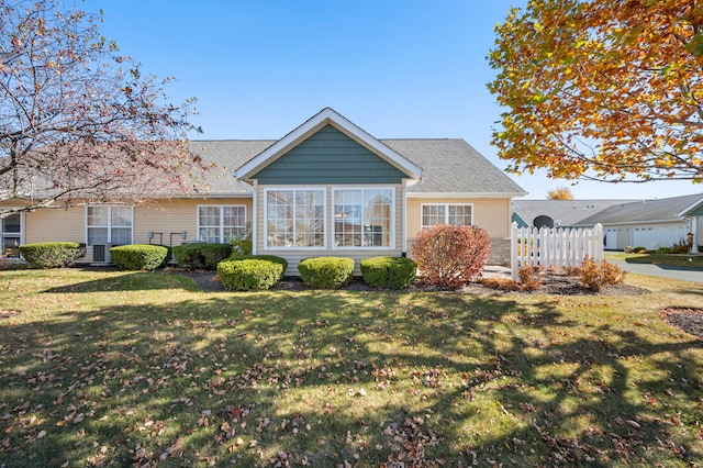 back of property with a lawn and central AC unit