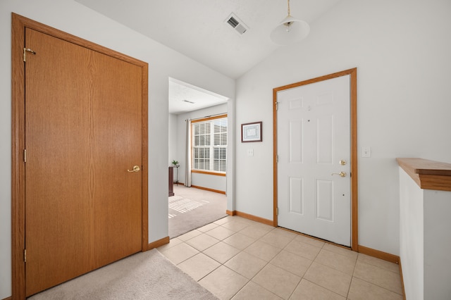 tiled foyer featuring lofted ceiling