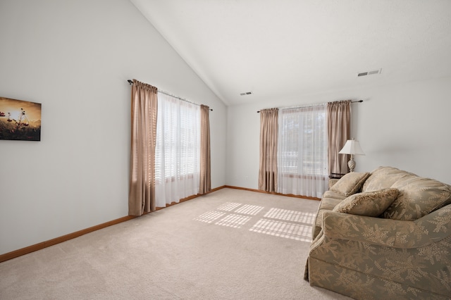 living room with carpet flooring and high vaulted ceiling