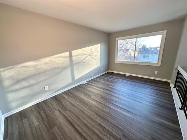 empty room featuring dark wood-type flooring