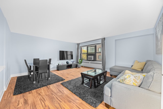 living room featuring radiator heating unit and hardwood / wood-style floors