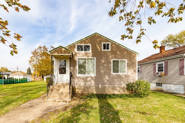 view of front of property featuring a front lawn and cooling unit