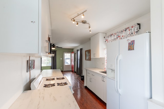 kitchen with dark hardwood / wood-style flooring, white appliances, ceiling fan, and white cabinets