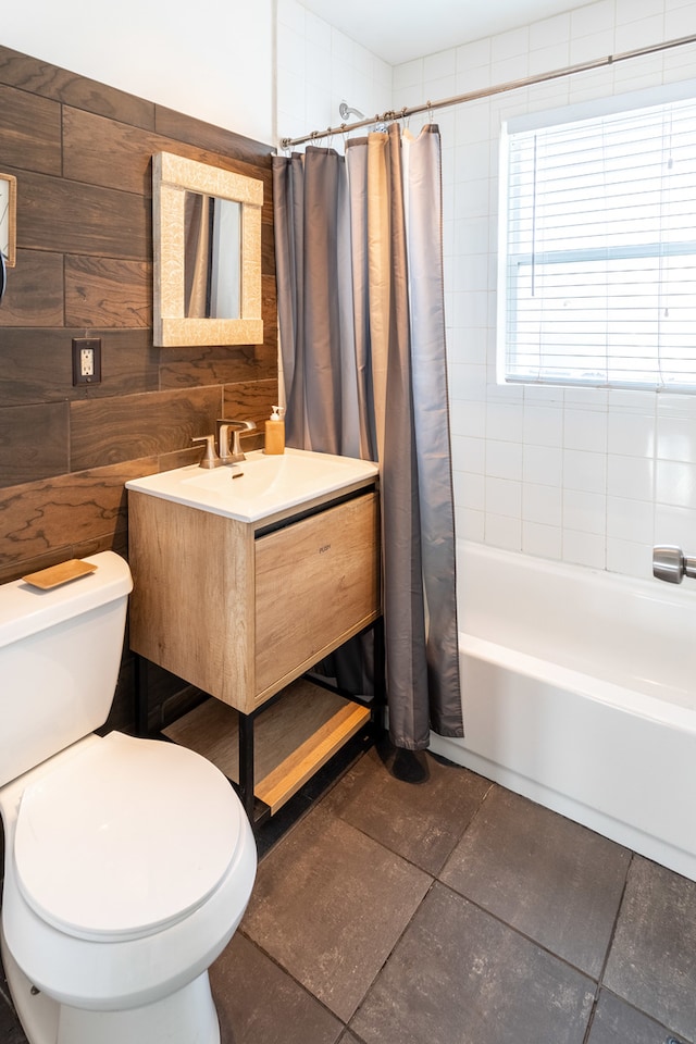 full bathroom featuring toilet, shower / tub combo, vanity, and wooden walls