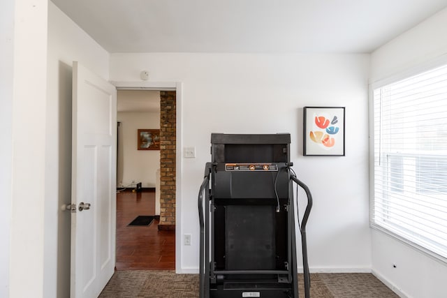 exercise room with dark hardwood / wood-style floors