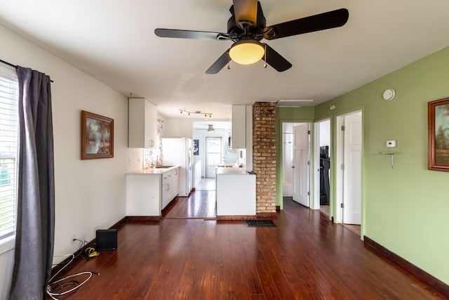 unfurnished living room featuring ceiling fan and dark hardwood / wood-style floors