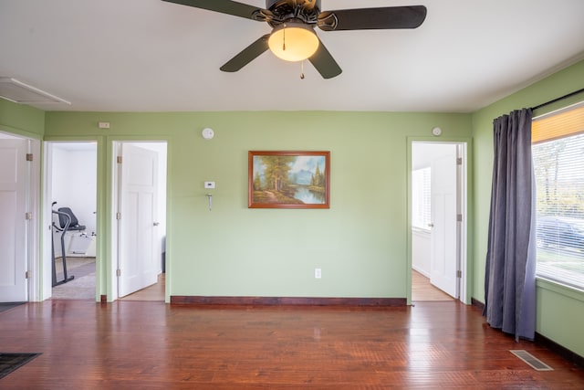 spare room featuring dark hardwood / wood-style floors and ceiling fan