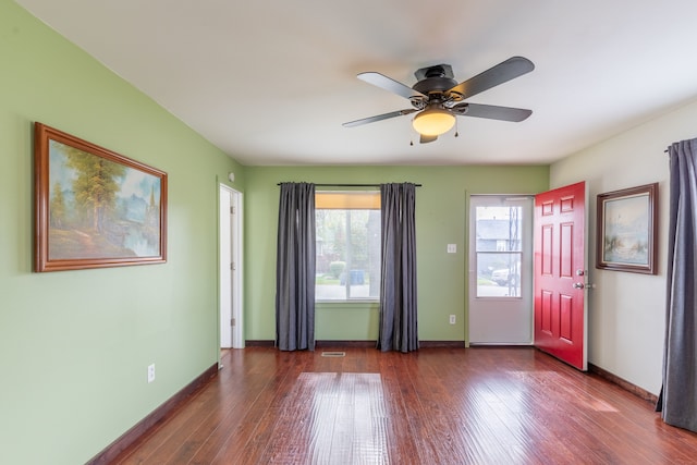 interior space featuring dark wood-type flooring and ceiling fan