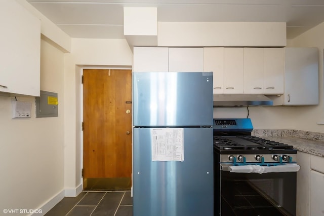 kitchen with white cabinets, wall chimney exhaust hood, light stone countertops, and stainless steel appliances