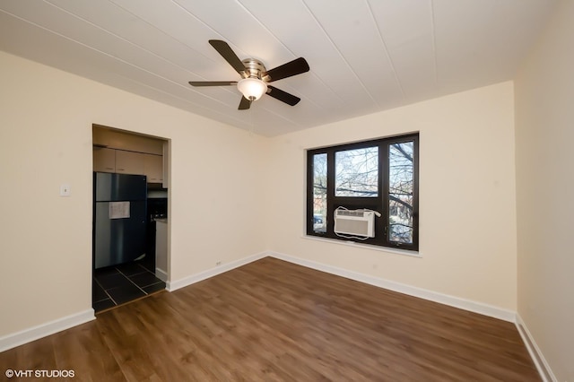 empty room with dark hardwood / wood-style flooring and ceiling fan