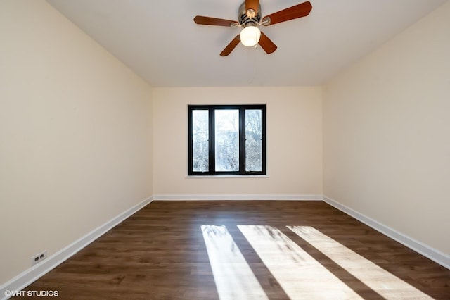 empty room with ceiling fan and dark hardwood / wood-style flooring