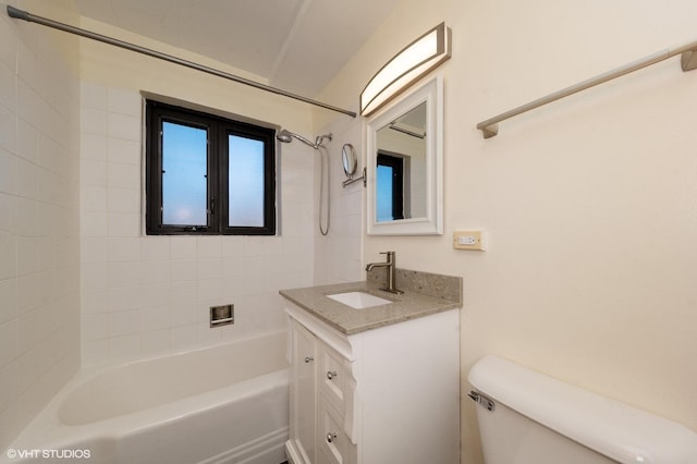 full bathroom with vanity, tiled shower / bath combo, and toilet