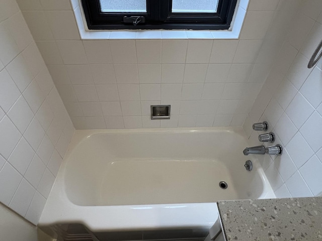 bathroom with a tub to relax in