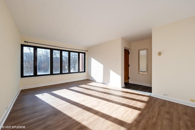 empty room with dark wood-type flooring