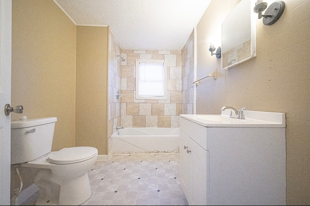 full bathroom with bathtub / shower combination, a textured ceiling, toilet, tile walls, and vanity