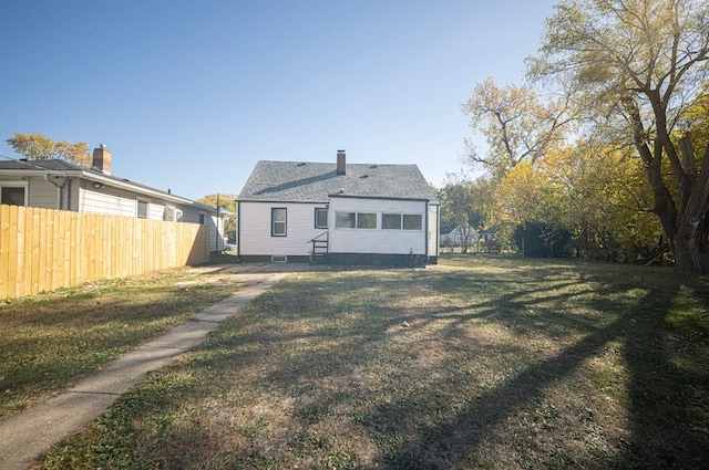 back of house featuring a yard