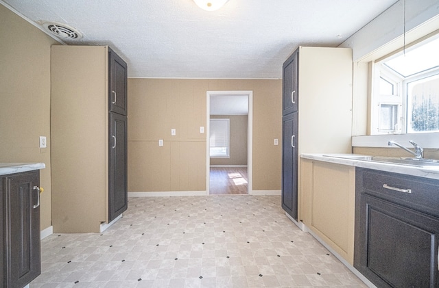 kitchen with a textured ceiling and sink