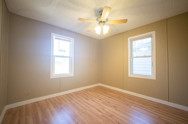 unfurnished room featuring ceiling fan, a textured ceiling, and light hardwood / wood-style flooring