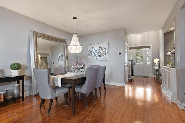 dining room featuring baseboards, an inviting chandelier, and wood finished floors