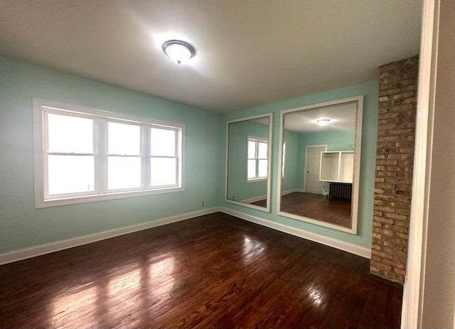 empty room with dark wood-type flooring