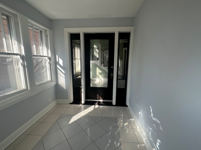 entryway with light tile patterned floors