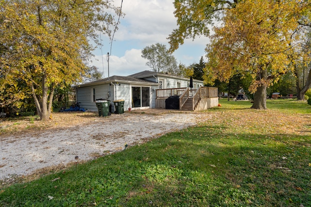 exterior space with a wooden deck and a lawn