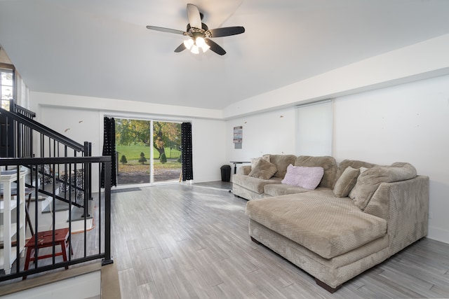 living room with hardwood / wood-style flooring, high vaulted ceiling, and ceiling fan